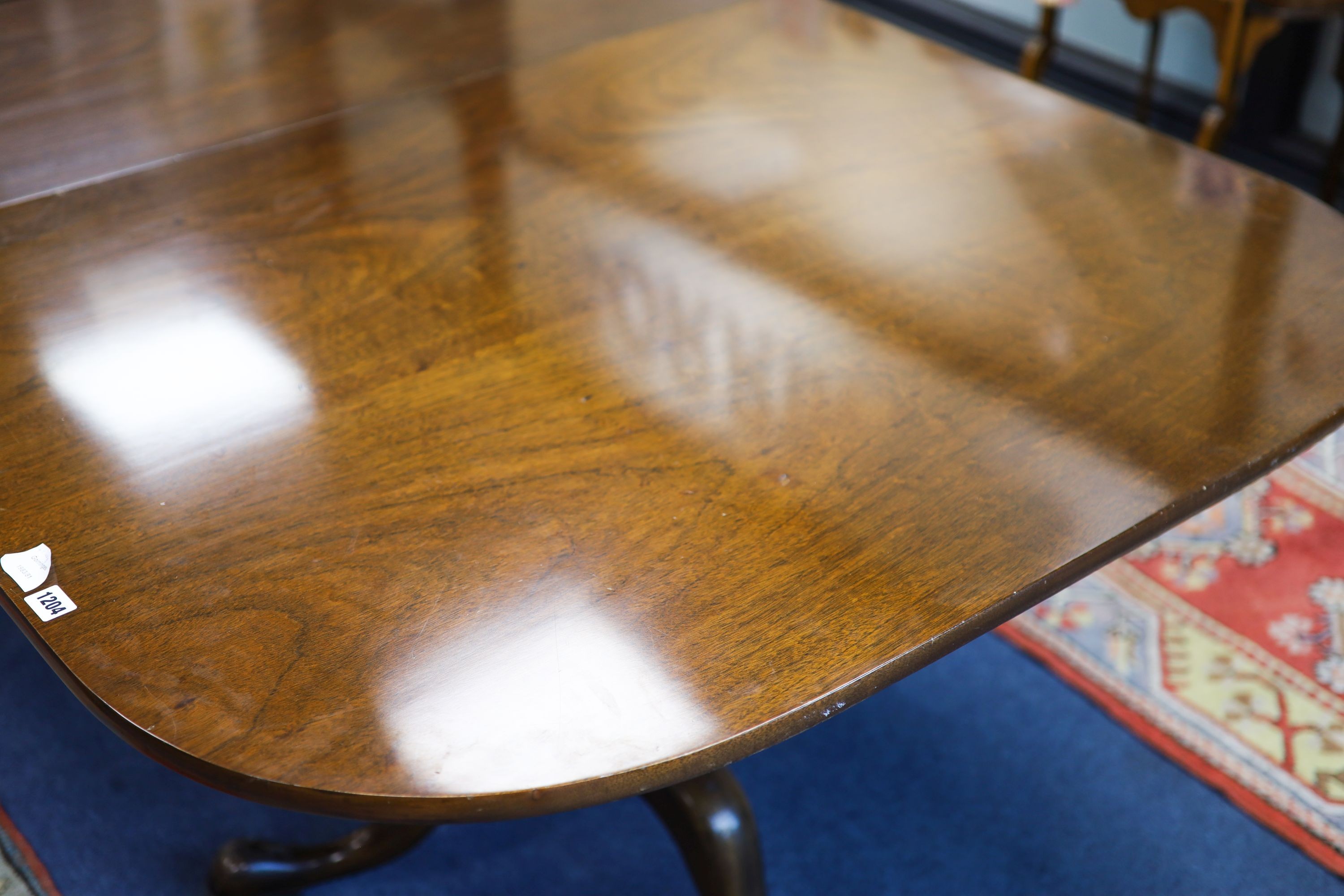 A George III style mahogany two pillar extending dining table, length 276cm extended, two spare leaves, width 114cm, height 72cm